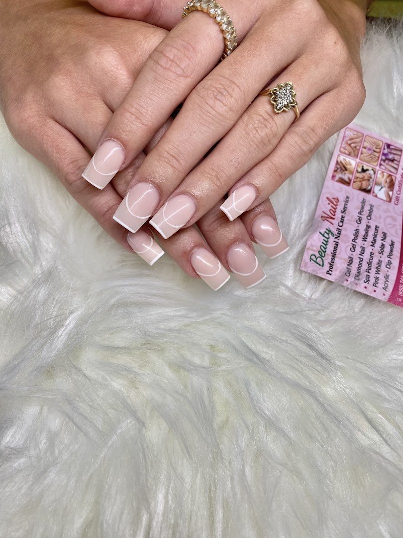 Bright nail salon interior with manicure stations.